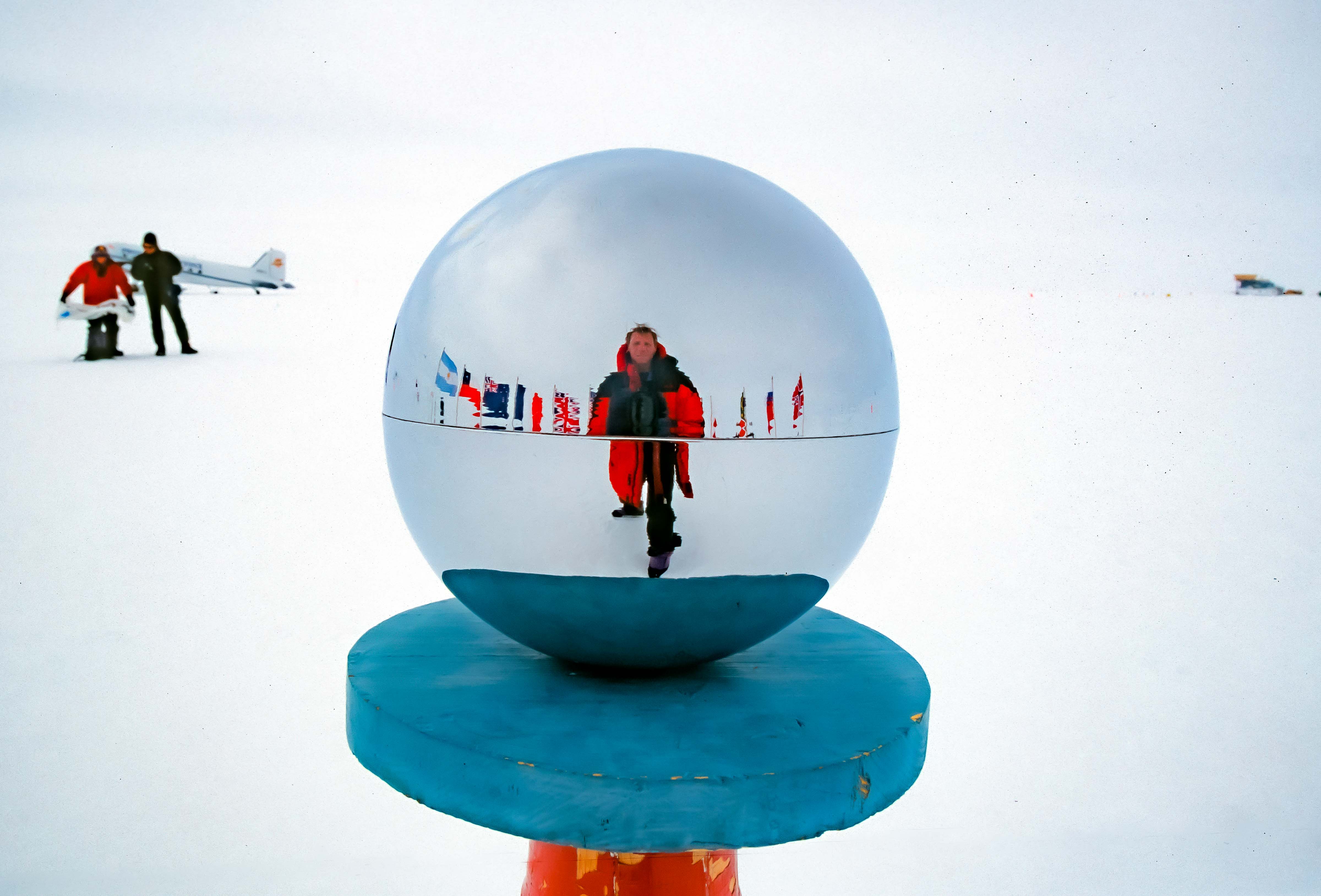 Antarctica, Jeff Shea at South Pole in Globe with Plane, 2001