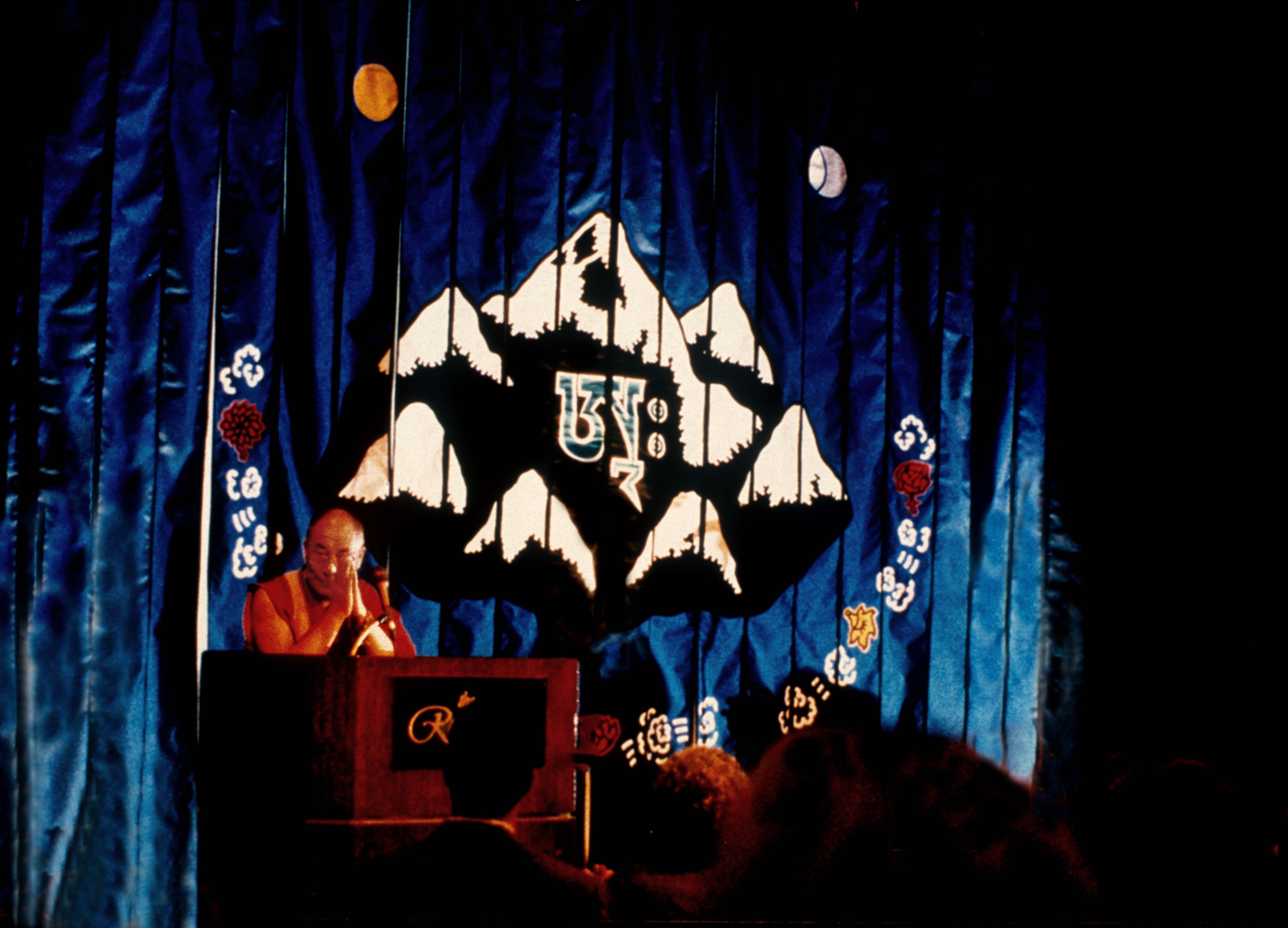 Dalai Lama Speaking in front of Seven Summits Banner